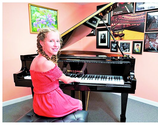 Student seated at piano